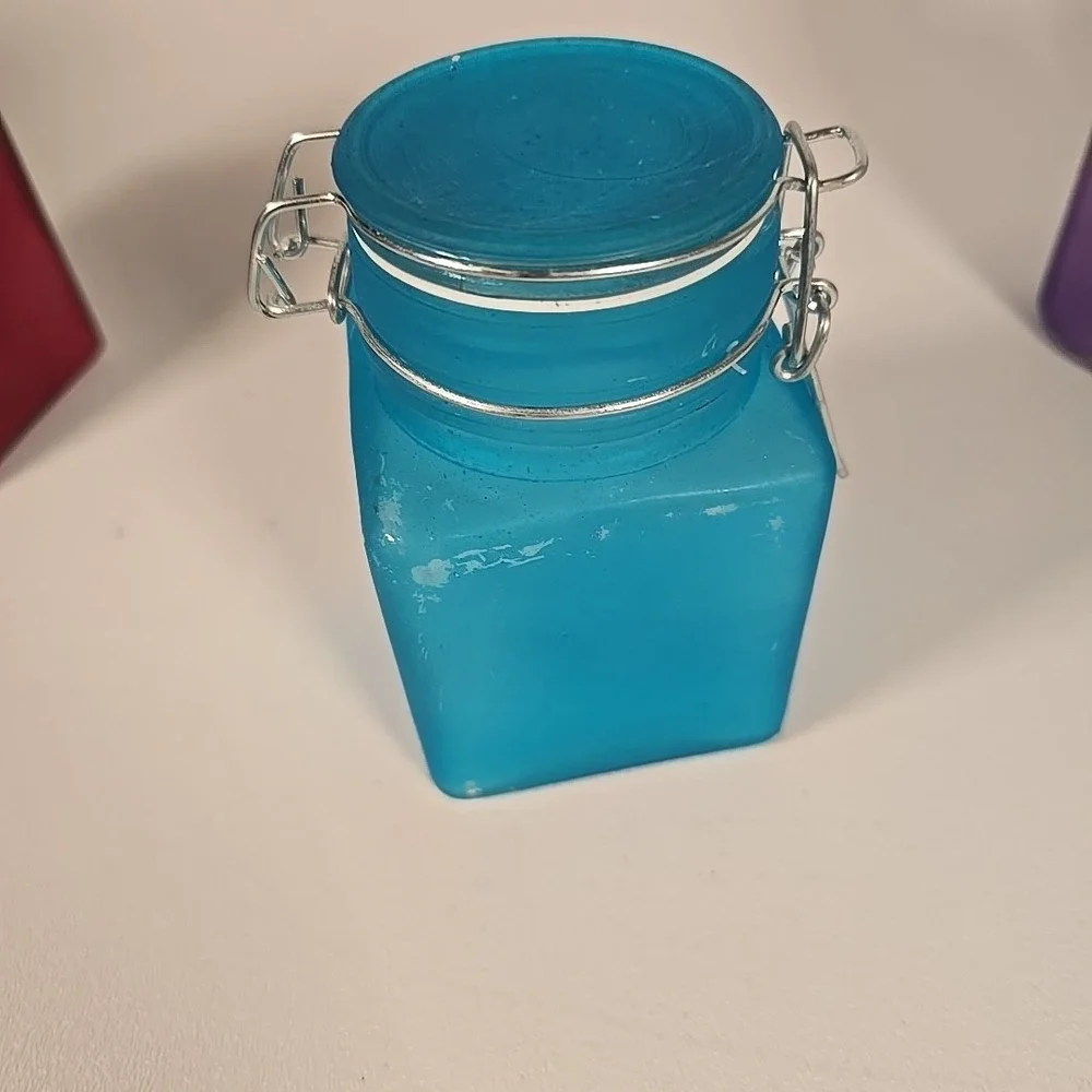 Set Of Four Colored‎ Glass Cannisters With Locking Tops Very Good Condition